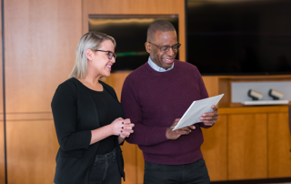 AWC-3772_EDIT_scaled two employees looking at a paper together