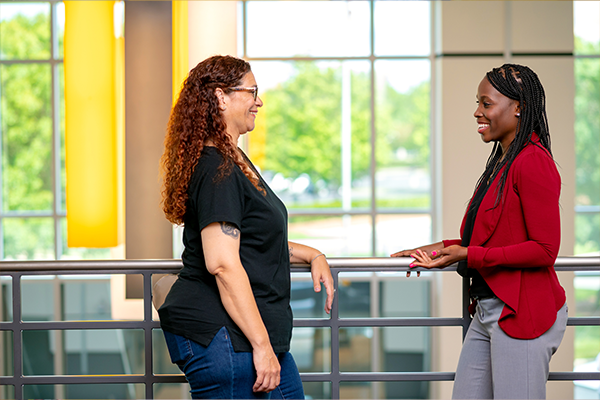 two woman employees talking with eachother