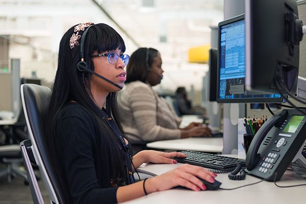 D&A-1 woman working with a headset at desk