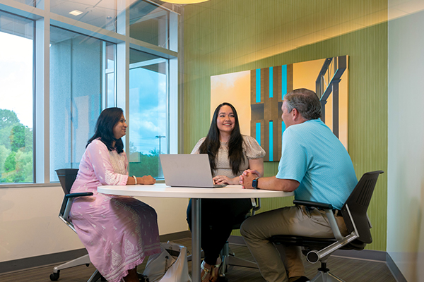 D&A-2 two women and man sitting at table working together