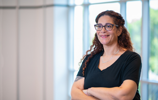 woman with cross arms smiling at camera