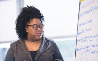 REG-3 woman using white board