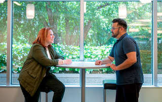 SRM-2 man and woman sitting at table talking to each other